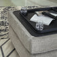 Ashley Express - Otomana Megginson con almacenamiento